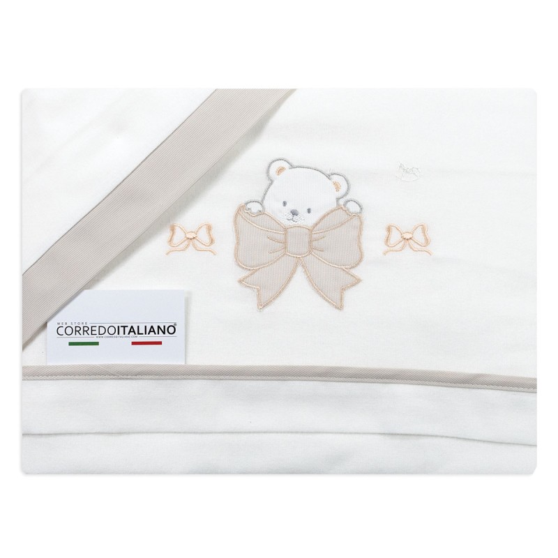 Close-up of bear and bow embroidery on warm flannel cot sheets. Close-up of bear and bow embroidery on warm flannel cot sheets.