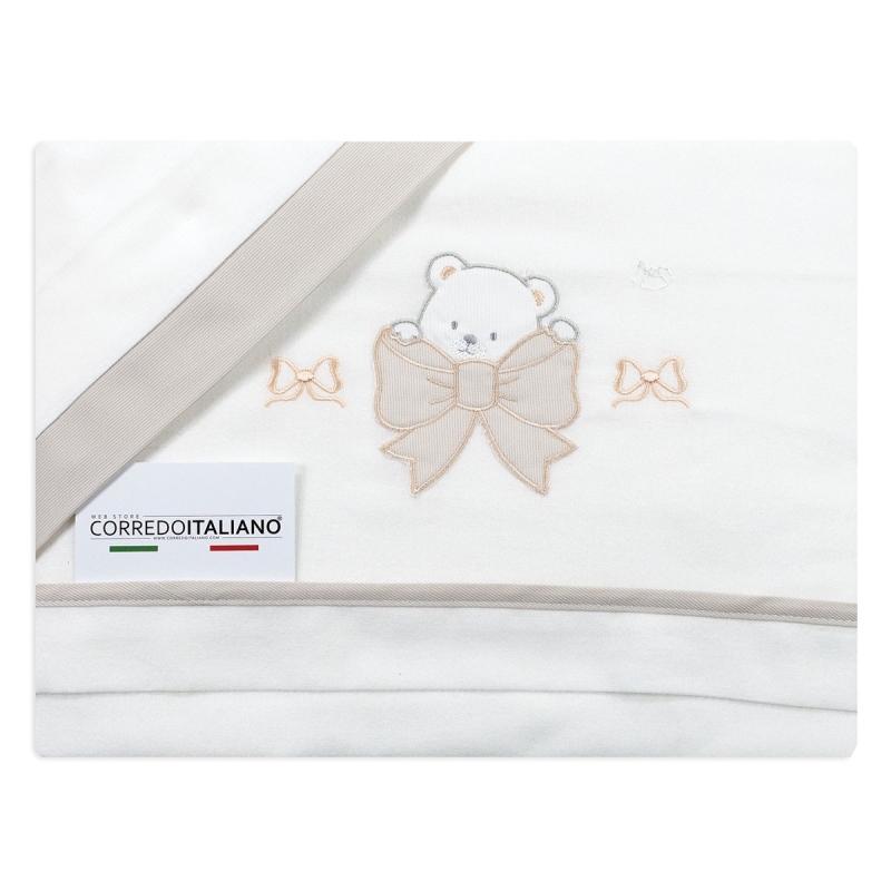 Close-up of bear and bow embroidery on warm flannel cot sheets.