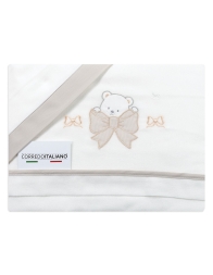 Close-up of bear and bow embroidery on warm flannel cot sheets.