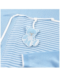 Detail of knitted newborn first outing layette set with teddy embroidery
