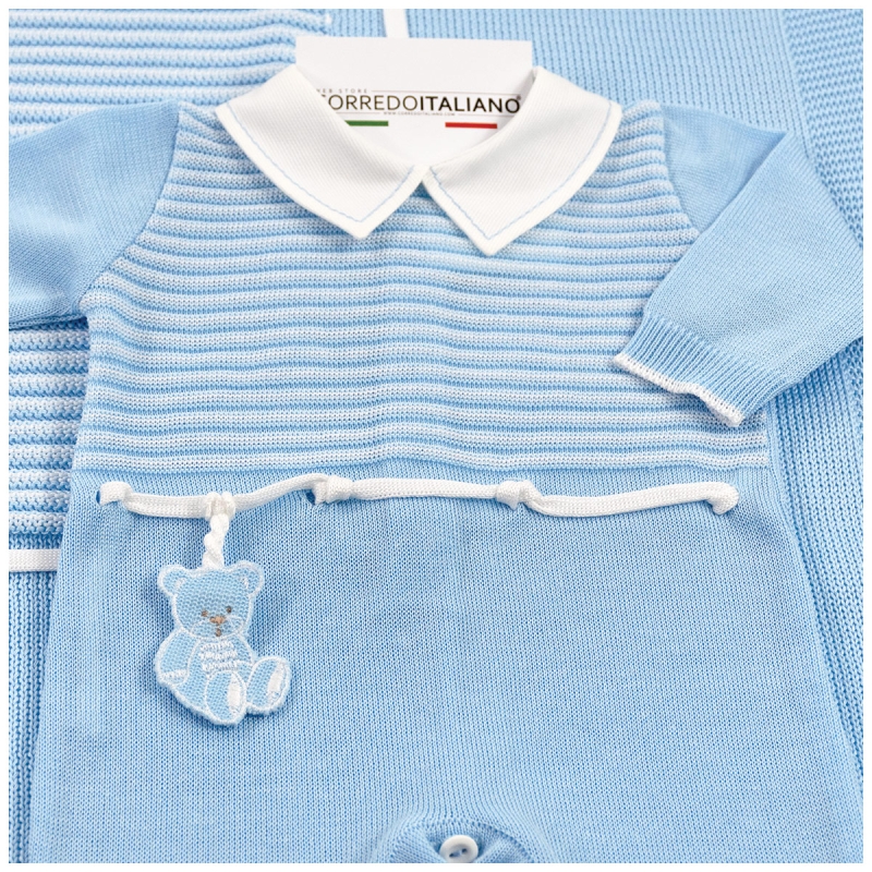 Detail of knitted newborn first outing layette set with teddy embroidery