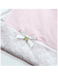 Detail of cotton jersey crib blanket with embroidered trim