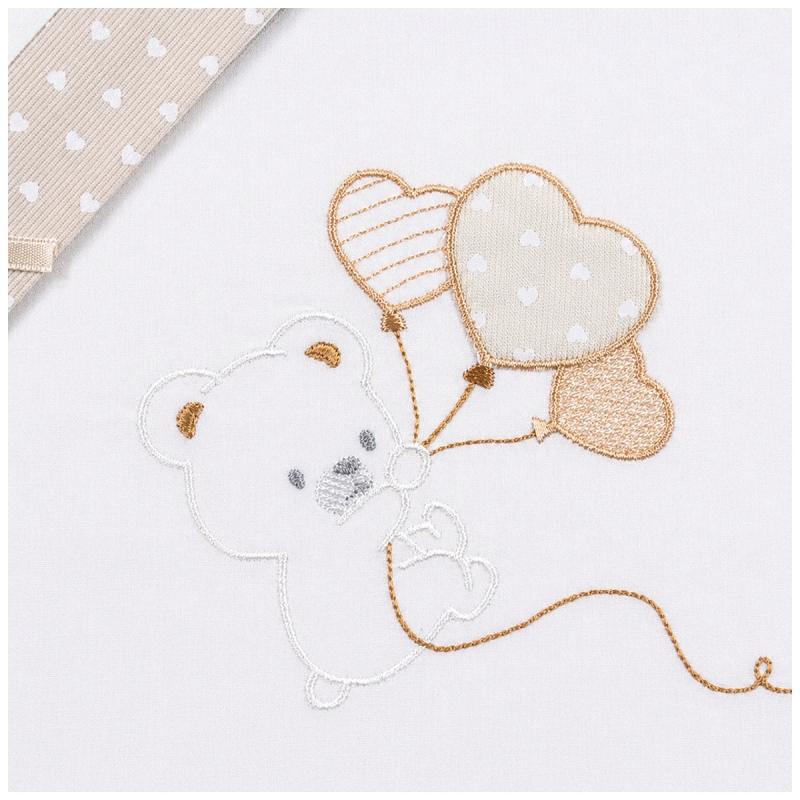 Close-up teddy bear balloon embroidery on soft natural baby fabric