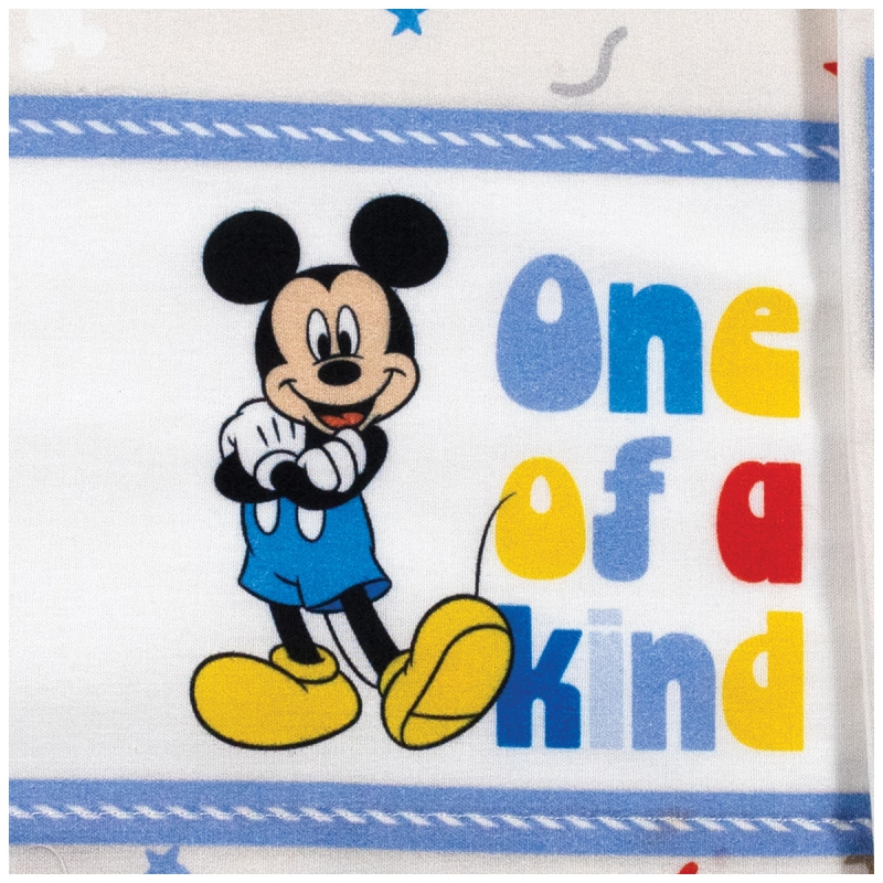 Close-up of Topolino print on creamy natural cotton fabric for newborn bedding