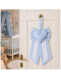 Home door decorated with baby birth bow in nursery style setting