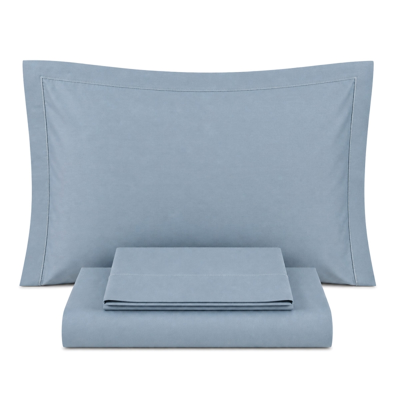 Cotton percale double bed sheet set with piping displayed on double size bed