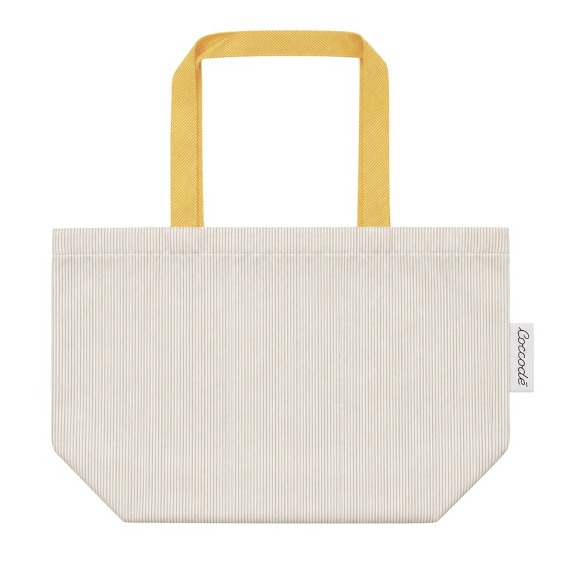 Coccode' Firenze girls' laundry bag in ivory fabric with yellow handles and a spacious bag shape