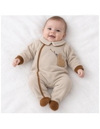 Tutina neonato in ciniglia beige con colletto arrotondato e bordini marroni a contrasto.