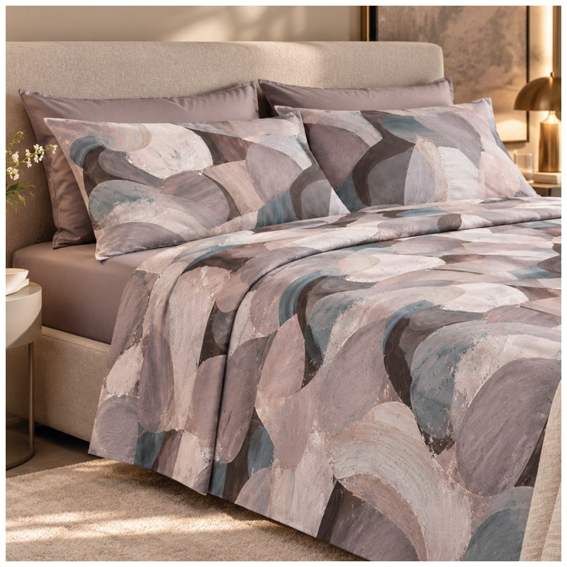 Double bed dressed with a printed summer flat sheet and plain fitted sheet