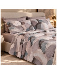 Double bed dressed with a printed summer flat sheet and plain fitted sheet